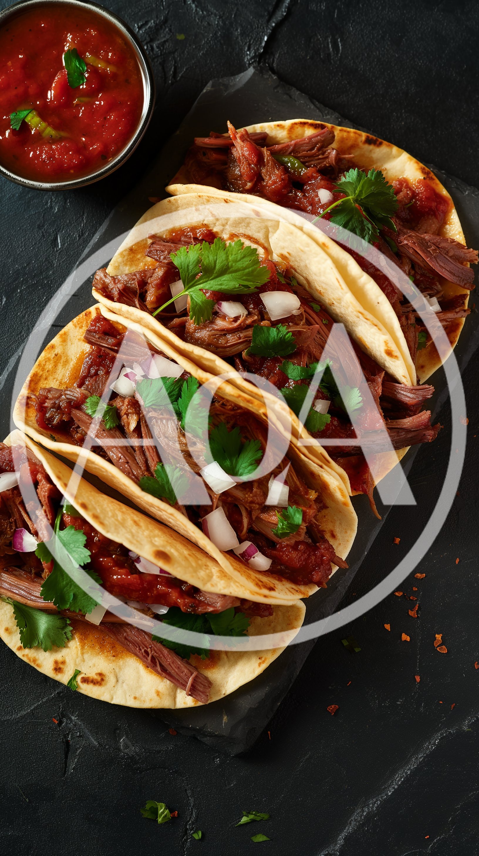 Three Beef Barbacoa Tacos on a Slate Platter