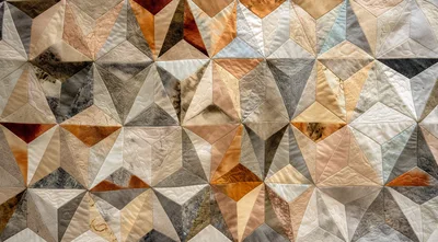 Geometric Patchwork Quilt With Earth Tone Fabric Patterns