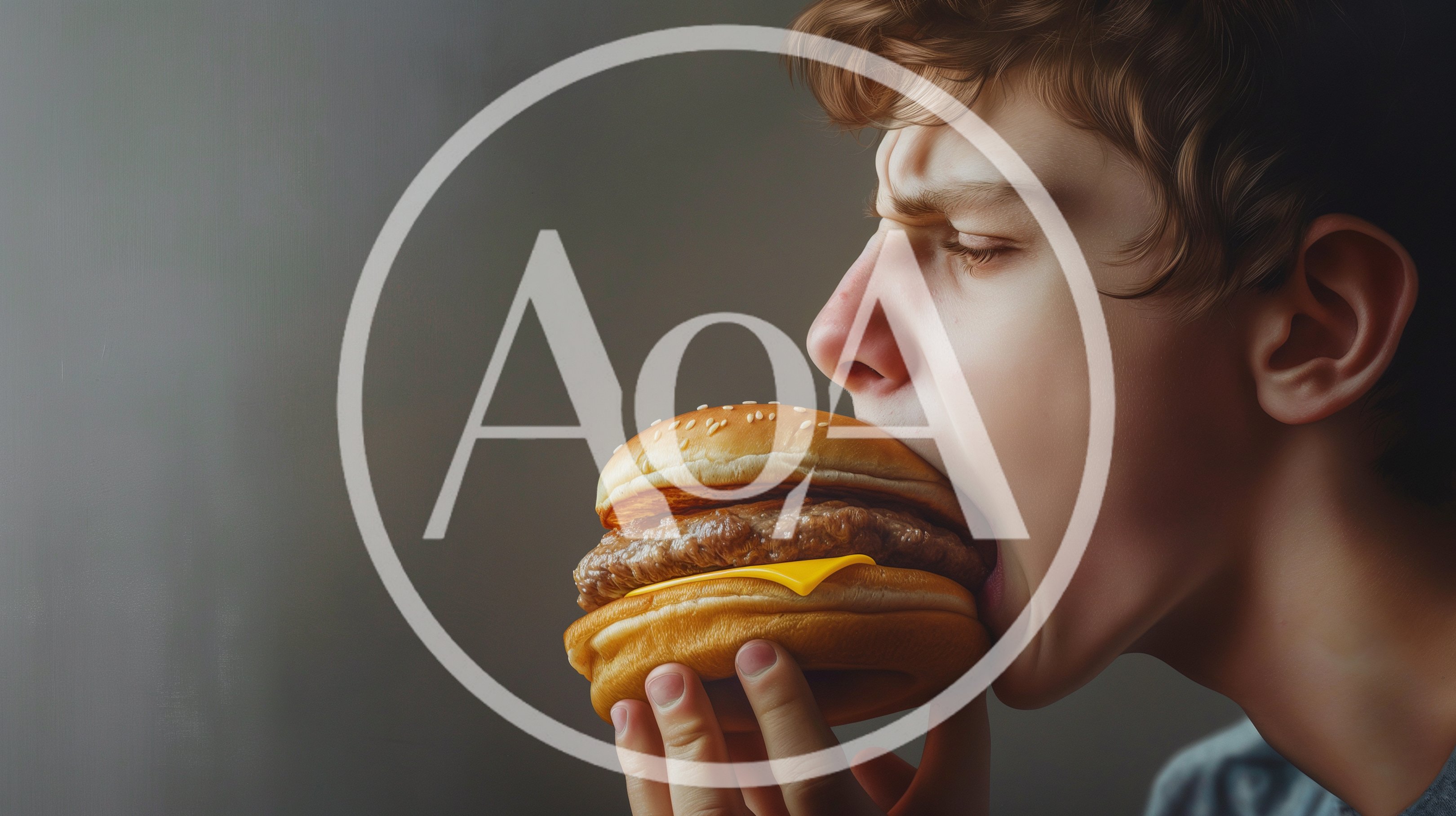 Young Man Eating A Cheeseburger With Intense Expression