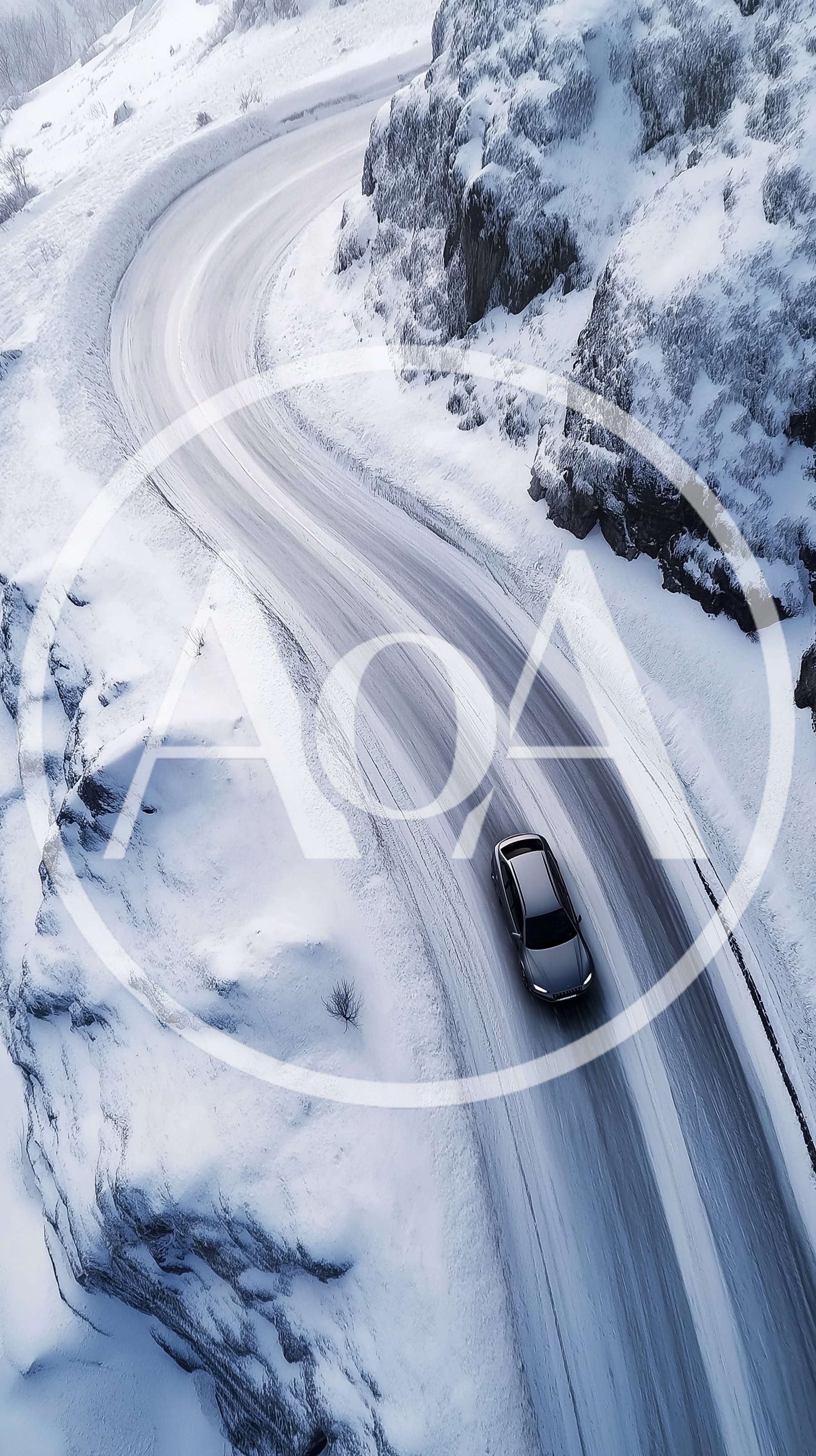 Aerial View Of A Car Driving On Snowy Road