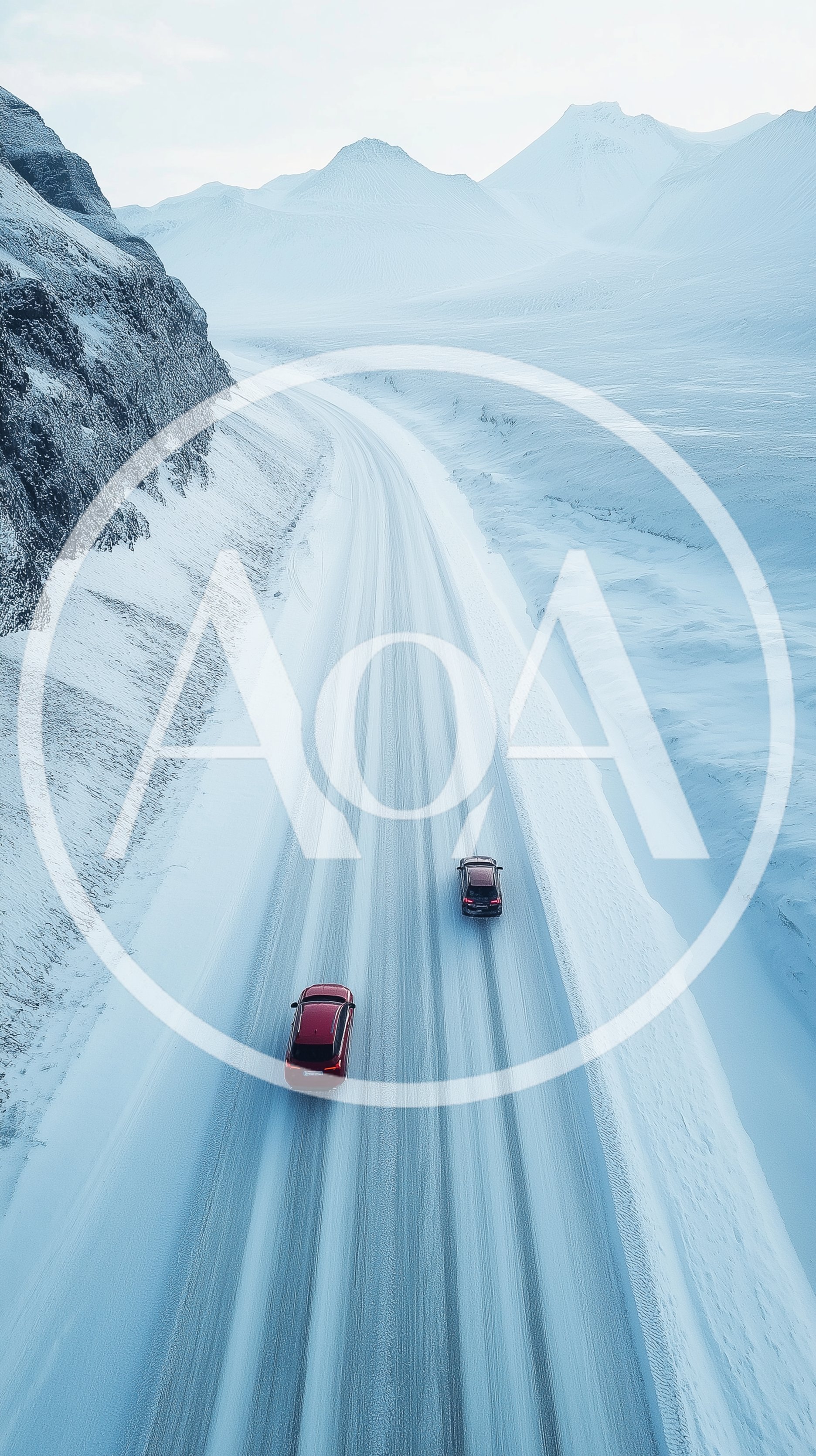 Two Cars Driving On A Snowy Mountain Road