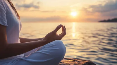 Woman Meditating In Lotus Position At Sunset