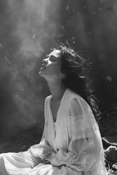 Woman In White Dress Sitting In Ethereal Smoke