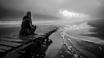 Solitary Woman Sitting On A Dilapidated Wooden Pier
