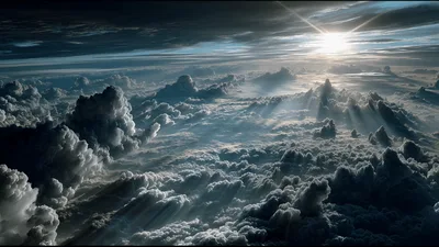 Aerial View Of Dramatic Sunlit Clouds Above Horizon