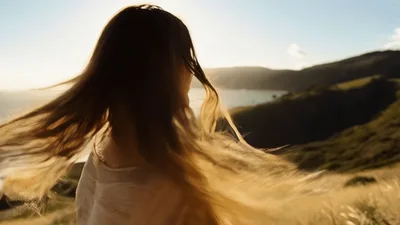 Young Woman Turning Her Head In Golden Hour Sunlight