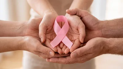 People Holding A Pink Breast Cancer Awareness Ribbon