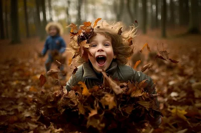 Joyful Child Playing With Autumn Leaves In Forest