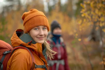 Young Woman Hiking With Backpack In Autumn Forest