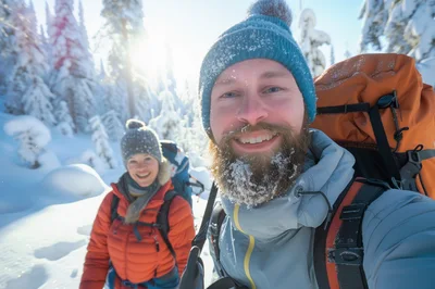 Couple Hiking Through Snowy Winter Forest
