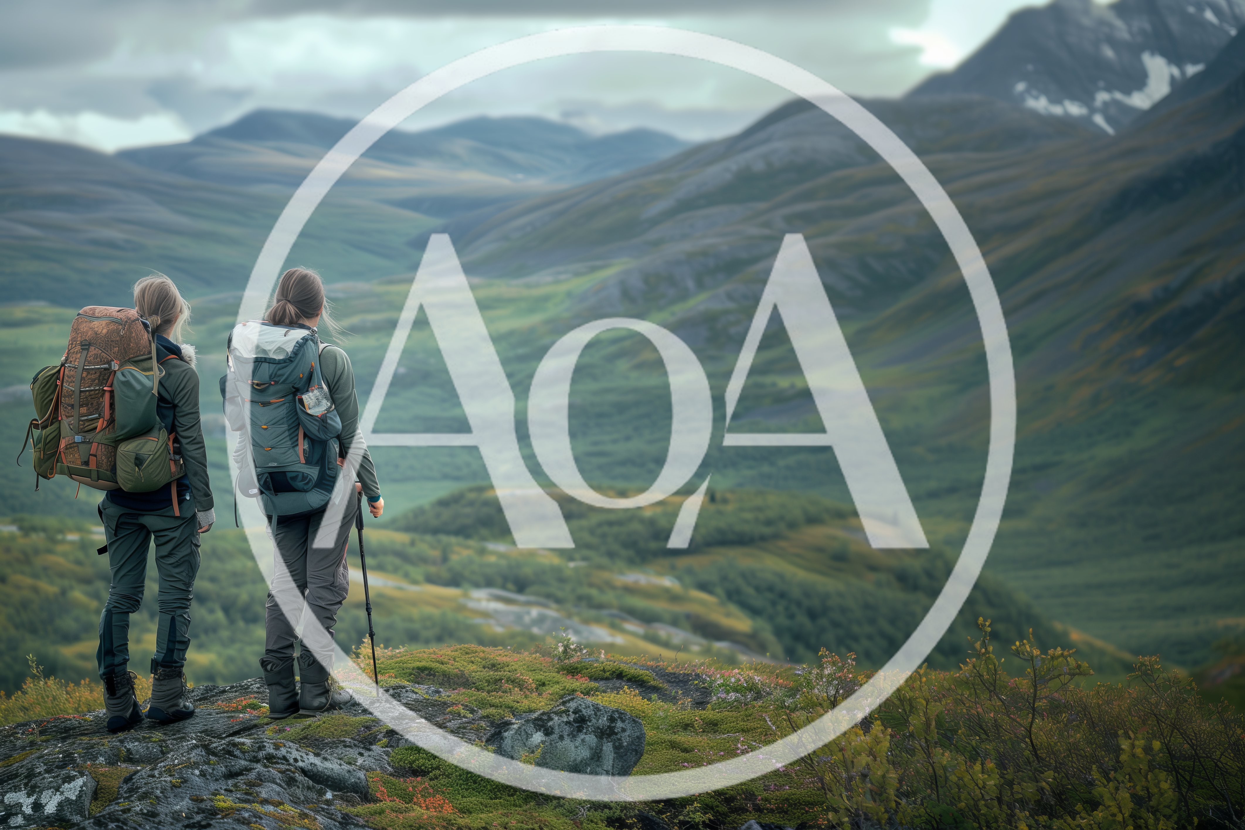 Two Hikers Standing On A Mountain Ridge