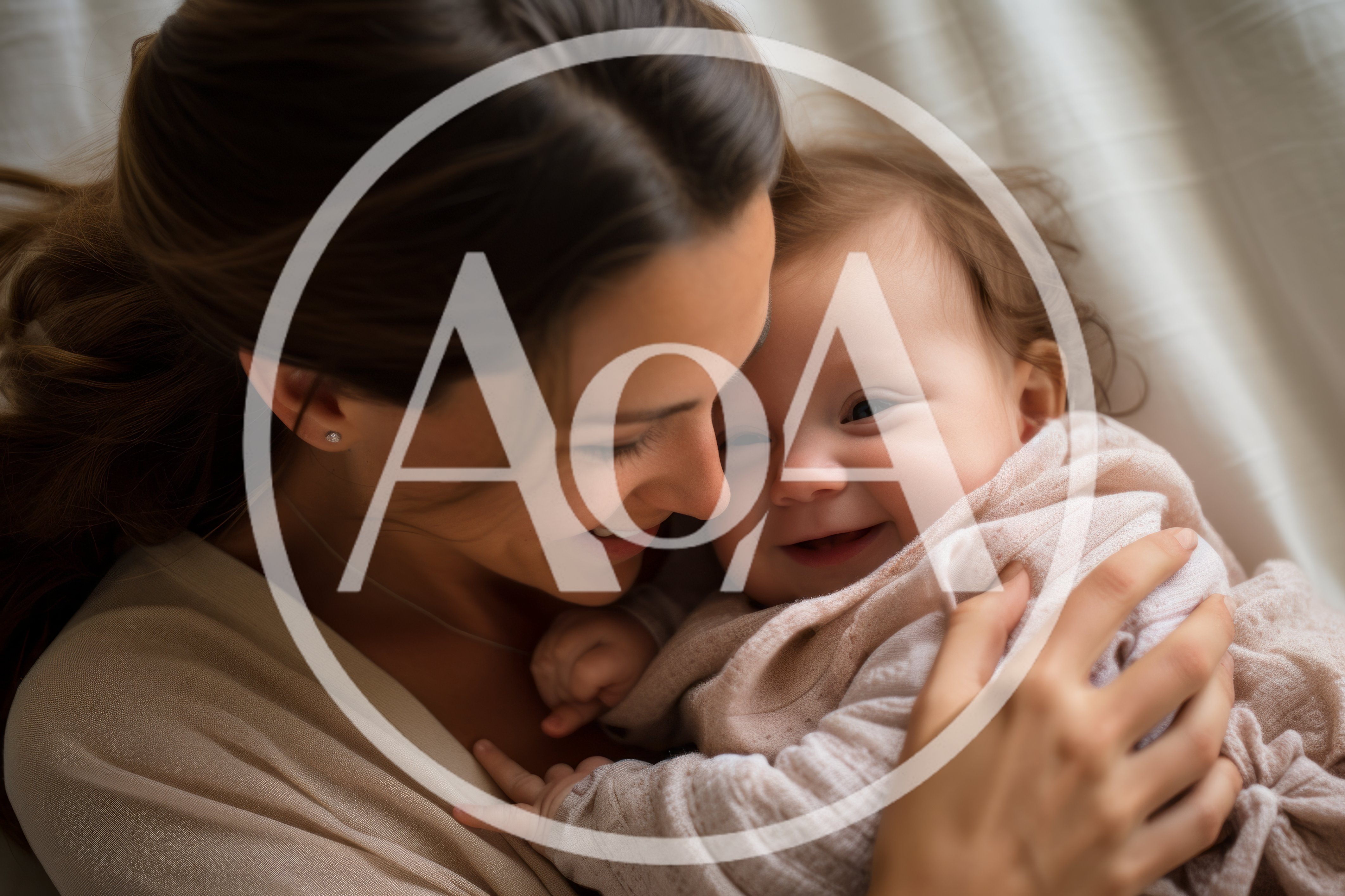 Mother Cuddling Her Smiling Baby Daughter