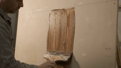Artisan Applying Wood Grain Texture To Board