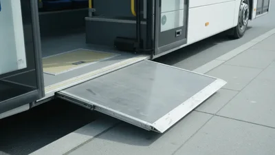 Bus Wheelchair Ramp Extending Outward At A Bus Stop