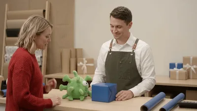 Professional Gift Wrapper Assisting Customer In Shop