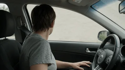 Woman Sitting In Driver Seat Looking Around