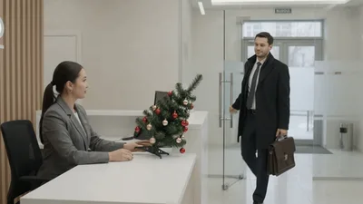 Receptionist Greets Businessman Arriving At Modern Office Lobby