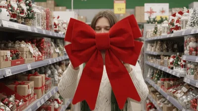 Young Woman Choosing Christmas Decorations In A Store
