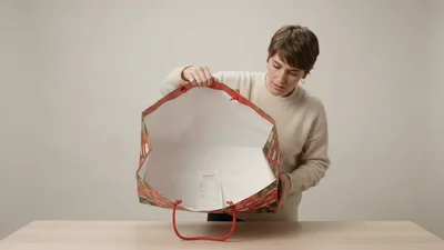 Woman Opening A Large Christmas Gift Bag