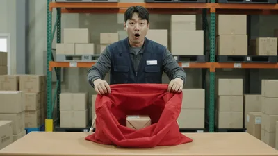 Warehouse Worker Opening A Large Red Santa Sack