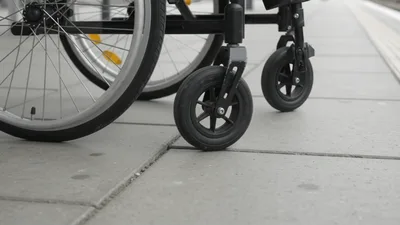 Wheelchair Wheels Resting On A Concrete Train Platform