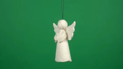 White Felt Angel Ornament Rotating On Green Screen