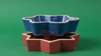 Blue And Red Star Shaped Bowls Stacked On Green