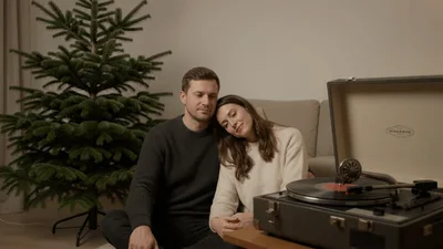 Couple Sitting Together Listening To Vinyl Record Player