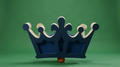 Blue Crown Balancing On A Small Orange Ball