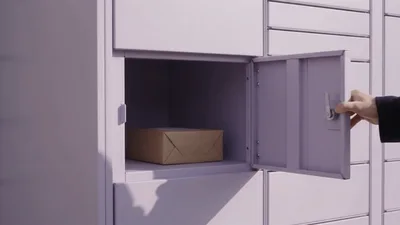 Person Opening A Parcel Locker Door