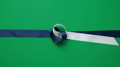 Blue and White Ribbons Tying Into A Bow