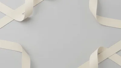 White Ribbons Forming A Frame On Grey Background