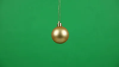 Golden Christmas Ornament Hanging Against Green Screen Background