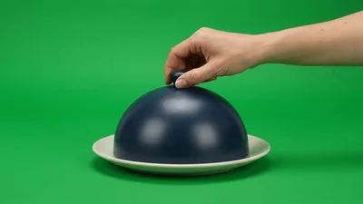 Hand Lifting Blue Cloche From Empty Plate