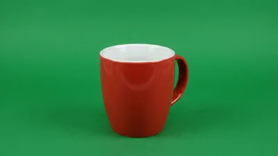 Red Ceramic Mug Rotating On Green Background