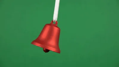 Red Christmas Bell Ornament Swinging On Green Screen