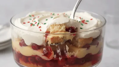Spoon Scooping Layered Trifle Dessert From Glass Bowl