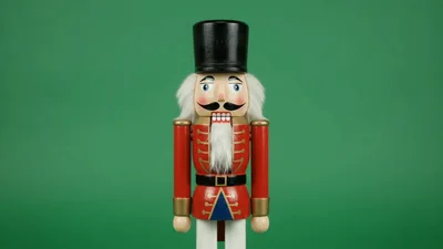 Traditional Wooden Nutcracker Soldier Standing On Green Background