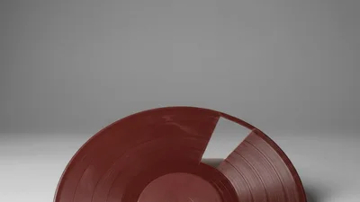 Red Vinyl Record Rotating Against A Minimalist Grey Background