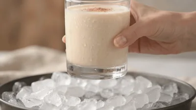 Hand Picking Up A Glass Of Iced Creamy Drink