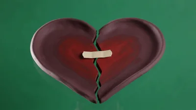 Broken Clay Heart Mended With Adhesive Bandage