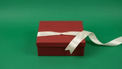 White Ribbon Untying From A Red Gift Box