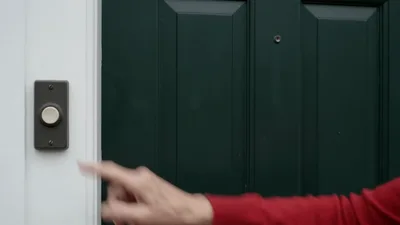 Elderly Woman Rings Doorbell And Door Opens