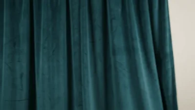 Dark Green Velvet Curtain Sliding Across White Wall