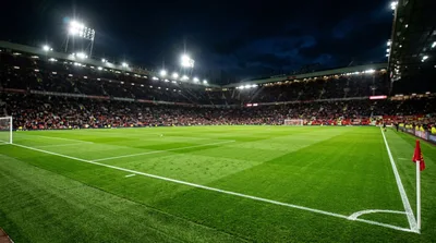 Empty Football Pitch At Old Trafford Stadium At Night