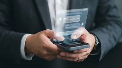 Businessman Using Smartphone With Holographic Chat Interface