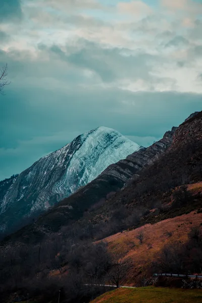 Snow Capped Mountain Peak Under Cloudy Sky