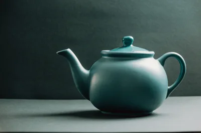 Teal Ceramic Teapot on Dark Background