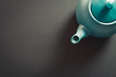Teal Ceramic Teapot on Dark Grey Background