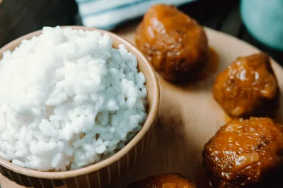 Bowl Of White Rice With Glazed Meatballs